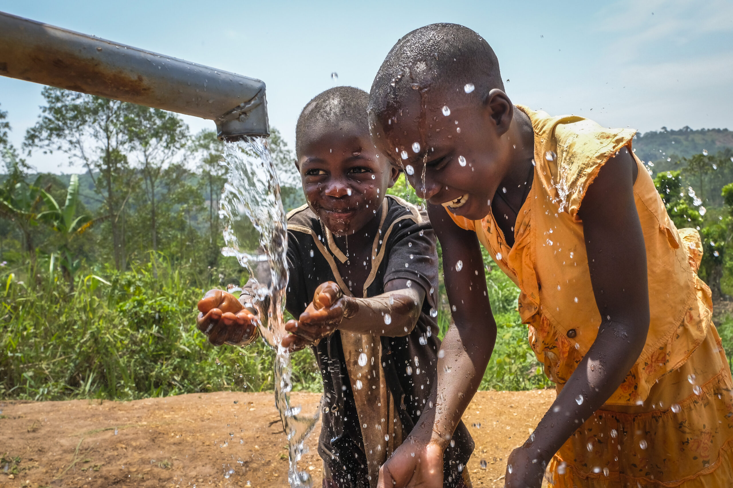 Having fun with water at the well in Lusera village, Mukono District - Uganda.