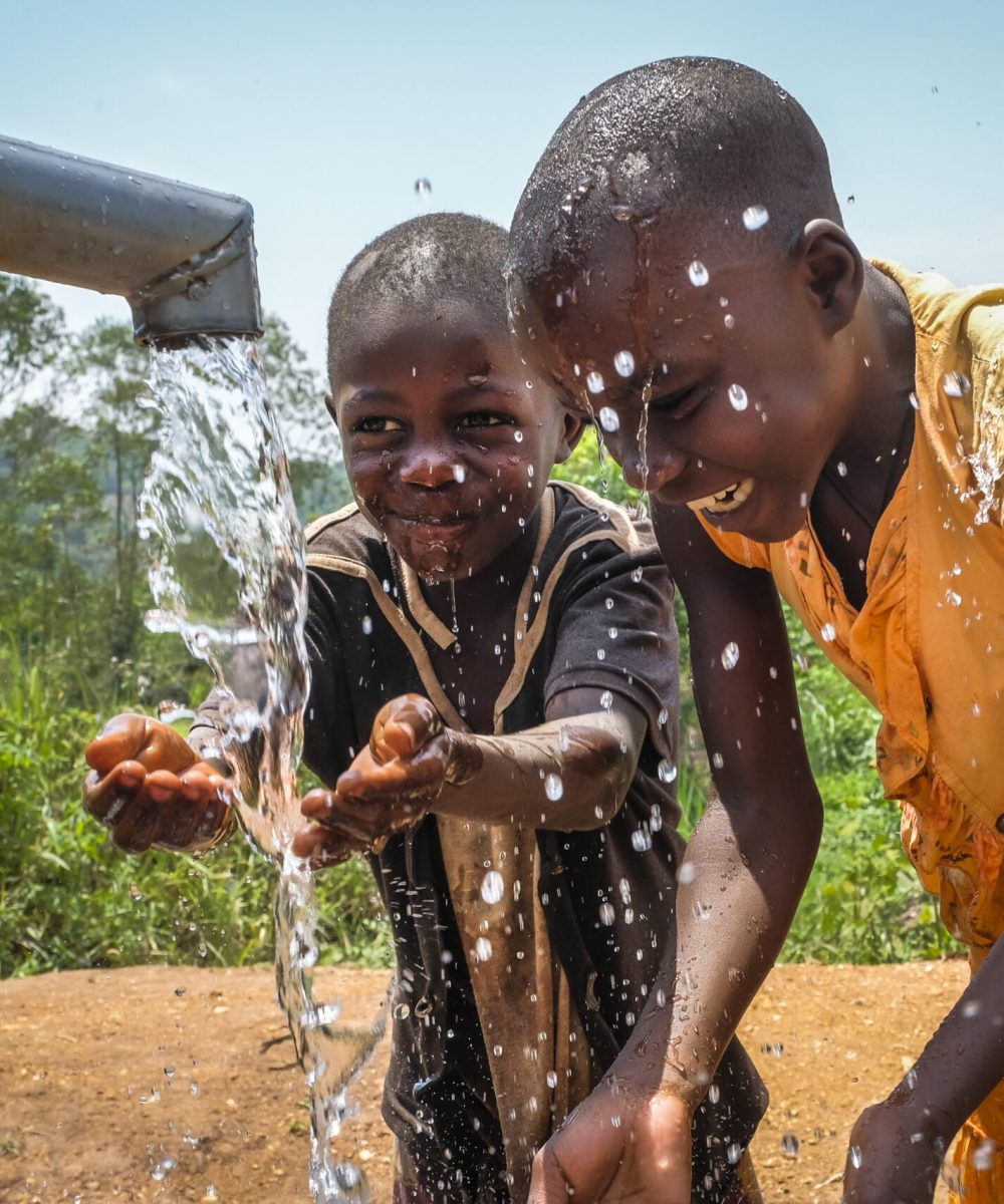 Having fun with water at the well in Lusera village, Mukono District - Uganda.